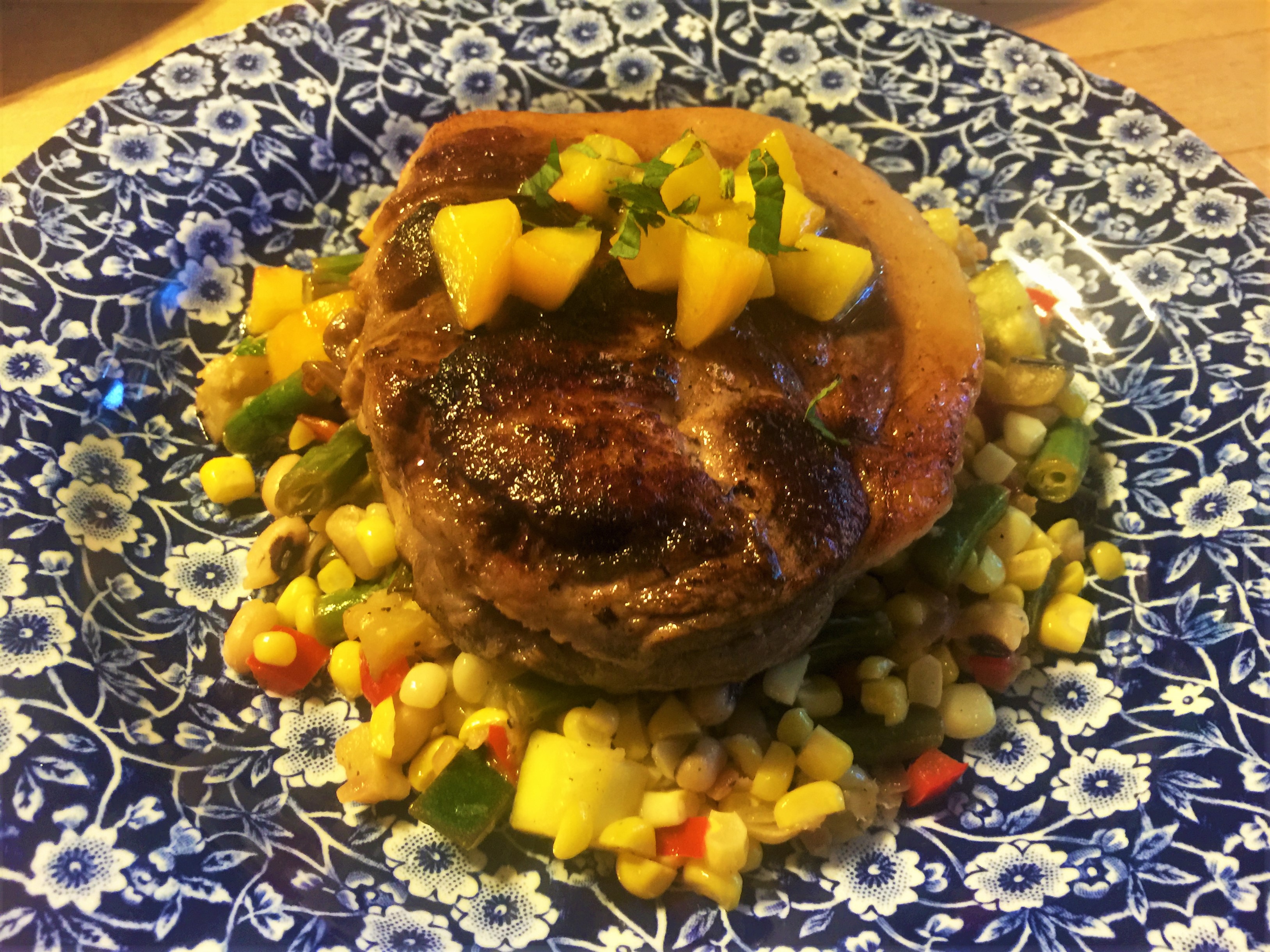 Heritage pork ribeye with peach demiglace and seasonal succotash from a dinner we preapred for guests at the Old Caledonian Bed & Breakfast.