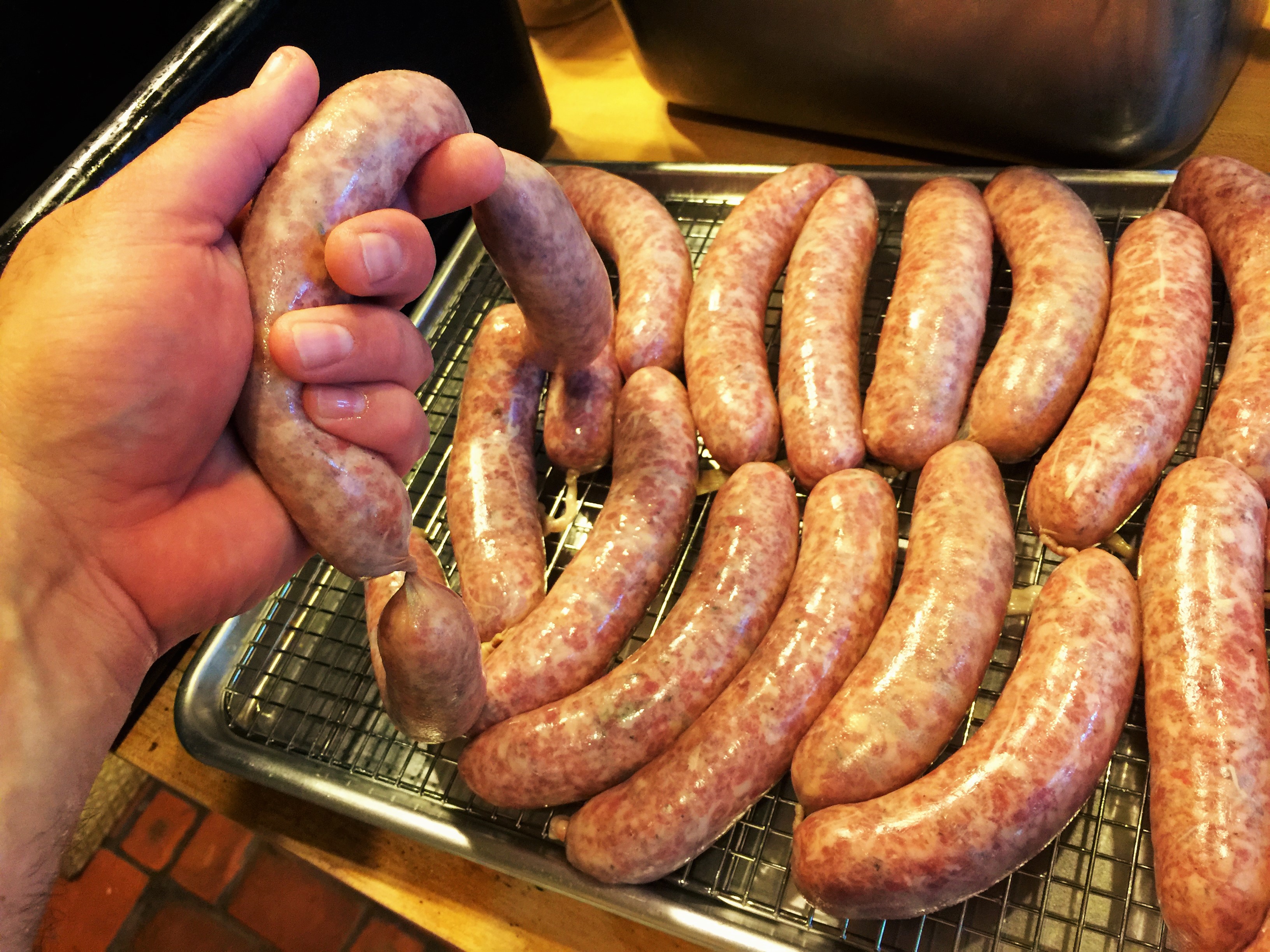 Hand cranking breakfast sausages in the kitchen of the Old Caledonian B&B